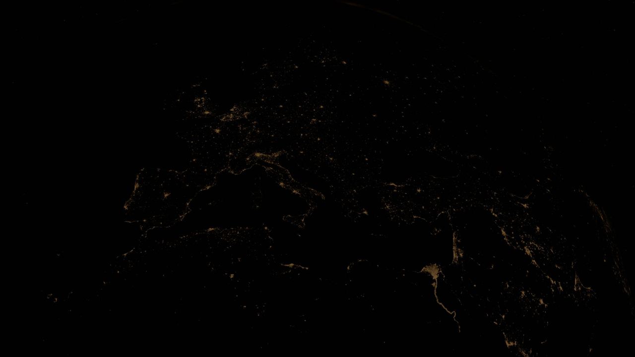 Earth at night viewed from space, showing illuminated global networks, behind the hero section